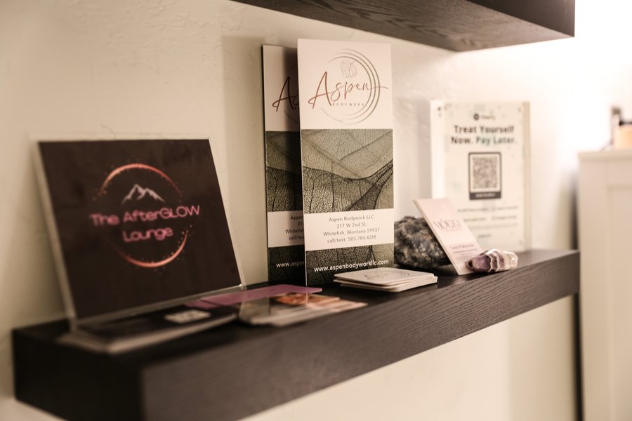 Reception shelf displaying The Afterglow Lounge branding and service brochures